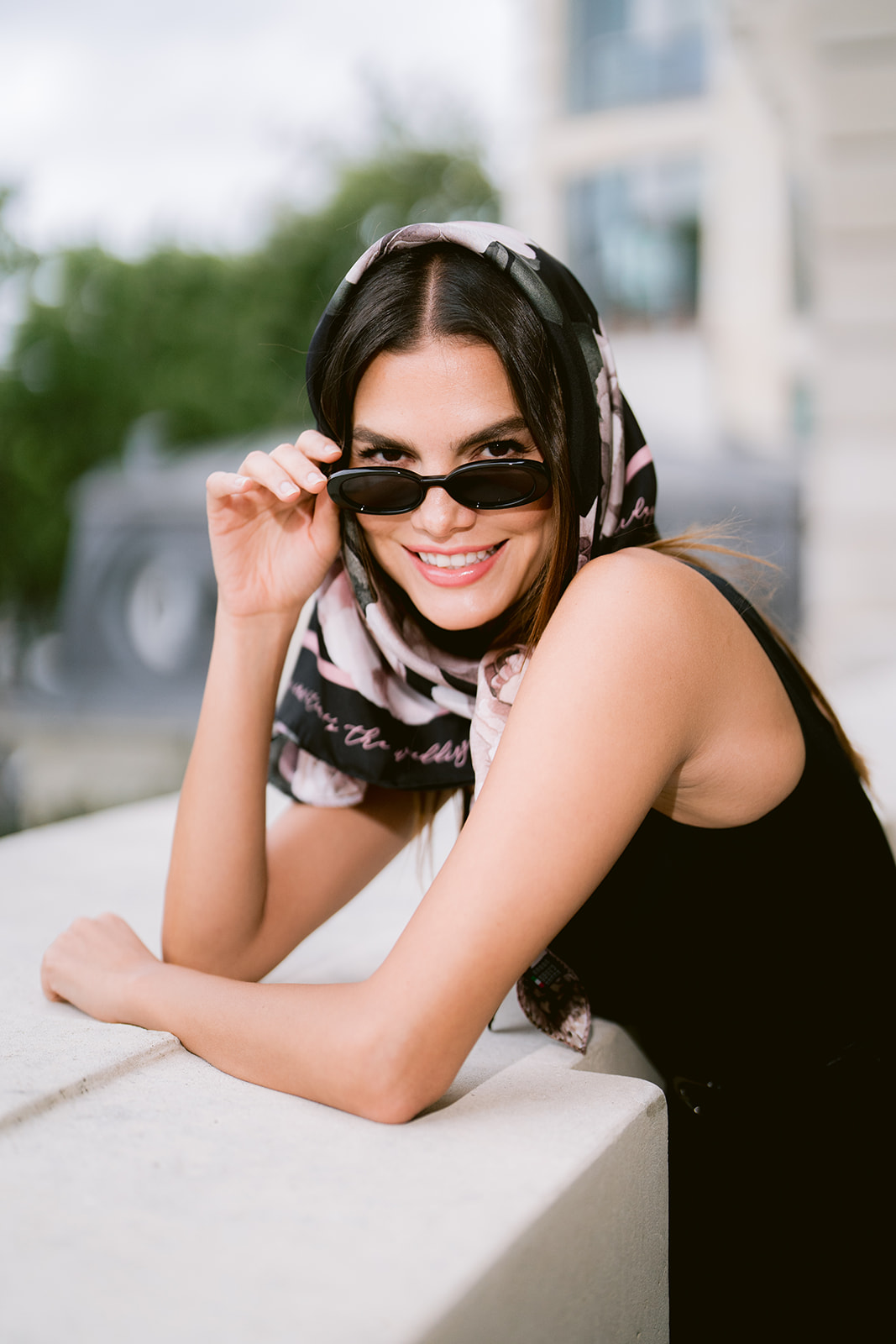 Model in a By Biehle floral silk headscarf and sunglasses, crafted in Como
