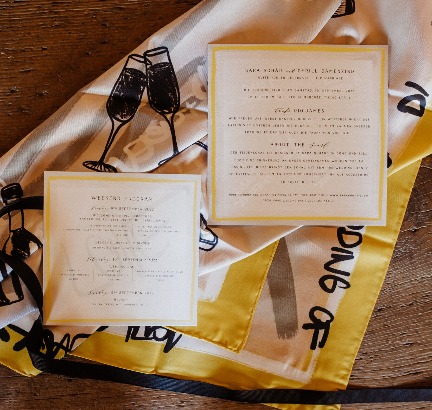 A wedding invitation suite lying on the custom silk scarf printed from the same artwork