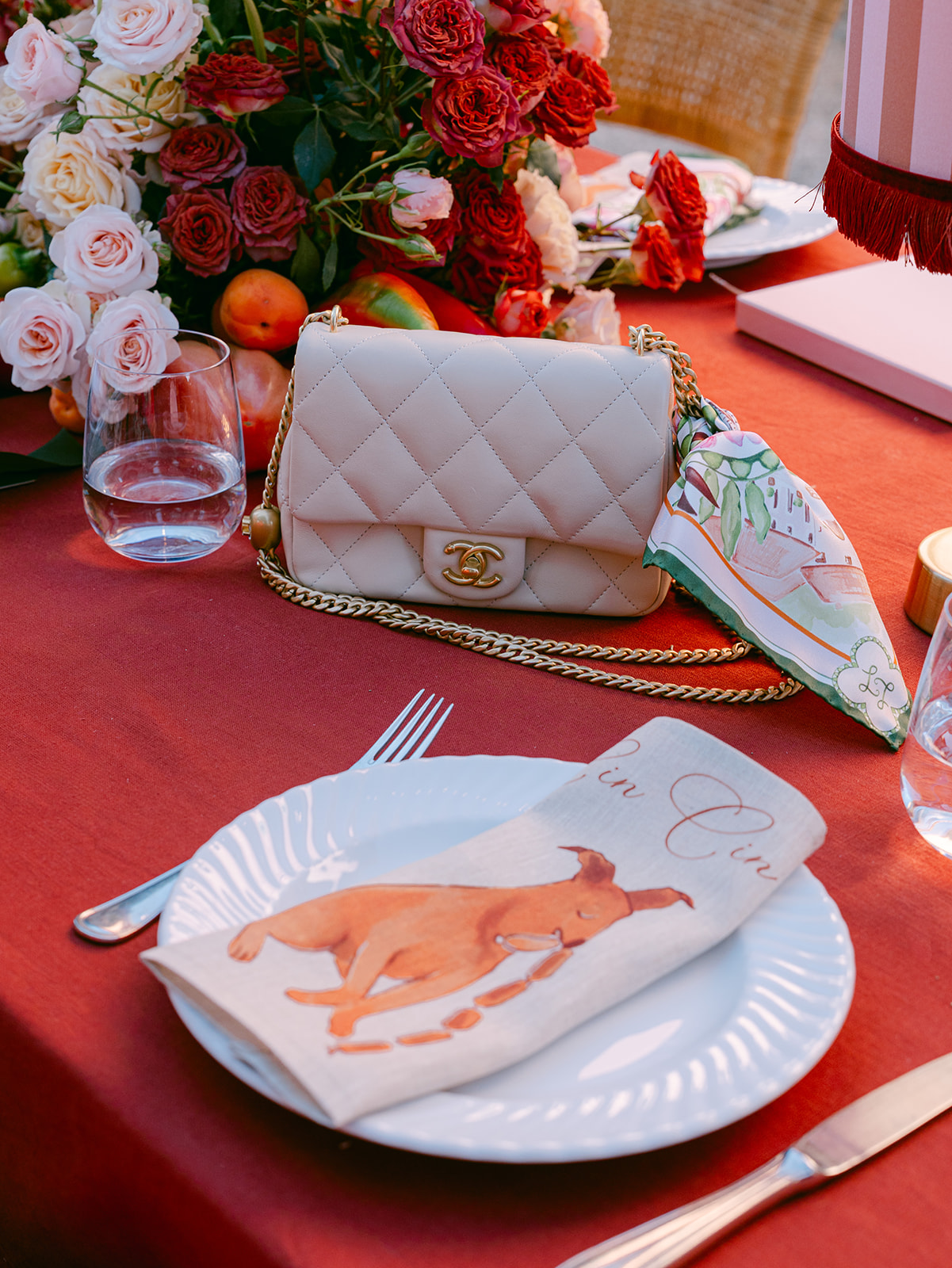 A custom silk pocket square tied on a guest's bag at a June wedding in Tuscany
