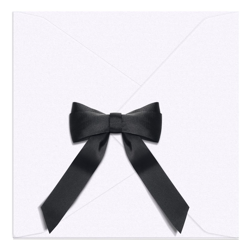 White scarf envelope closed, with a black ribbon bow on the front