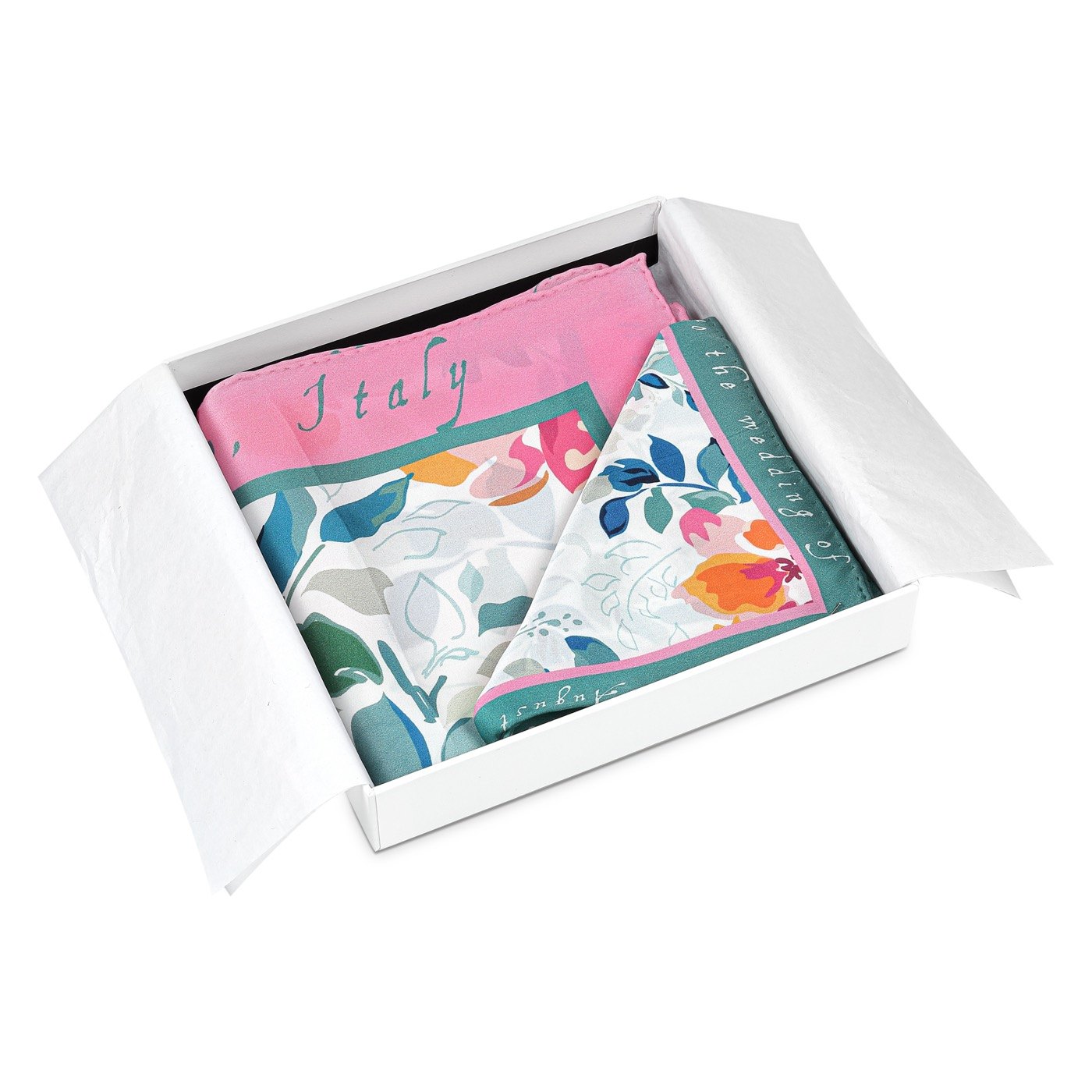 Handmade white gift box, lid off, with a silk scarf folded in white silk paper